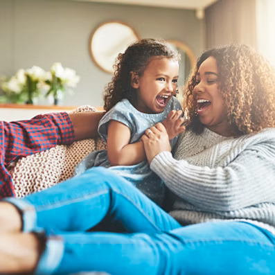 Happy mother and child on couch